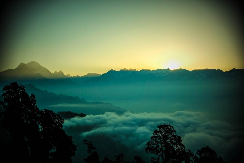 The sun rising over the mountaintops in Himalaya, Nepal